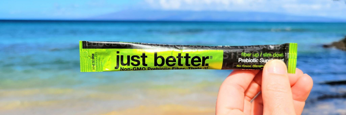 just better stick pack held up against an ocean view.