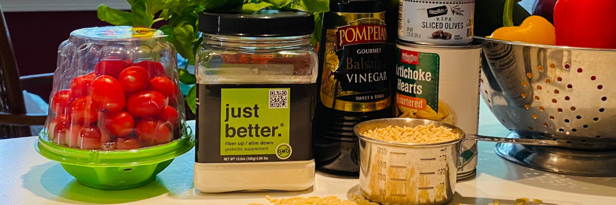 A container of just better prebiotic fiber sits among healthy ingredients for meal prep.