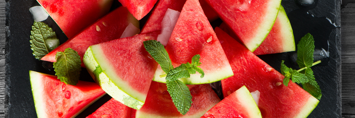 Watermelon slices on a slate countertop.