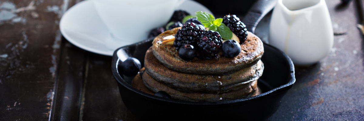 A stack of pancakes with berries.