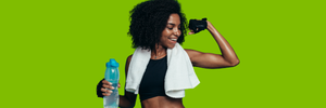 A smiling woman holding a water bottle flexes her other arm.