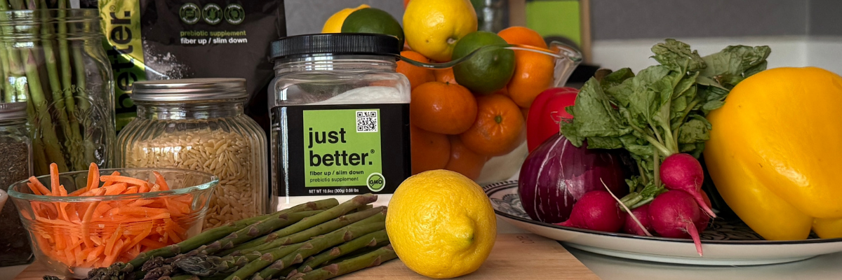 A container of just better fiber with salad ingredients nearby.