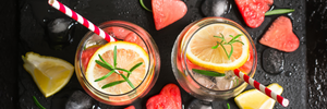 Watermelon-Rosemary Citrus Infused Water on a dark stone surface with heart-shaped watermelon pieces.