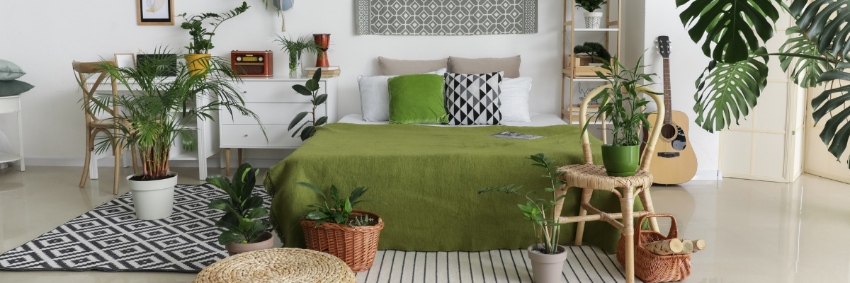 A cozy bedroom with light green accents and plants.
