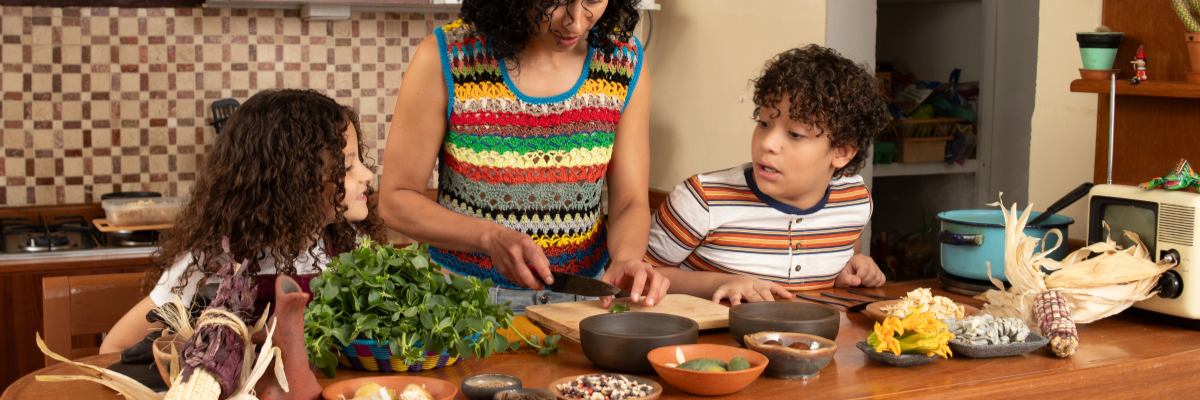 A family in the kitchen preparing healthy food.